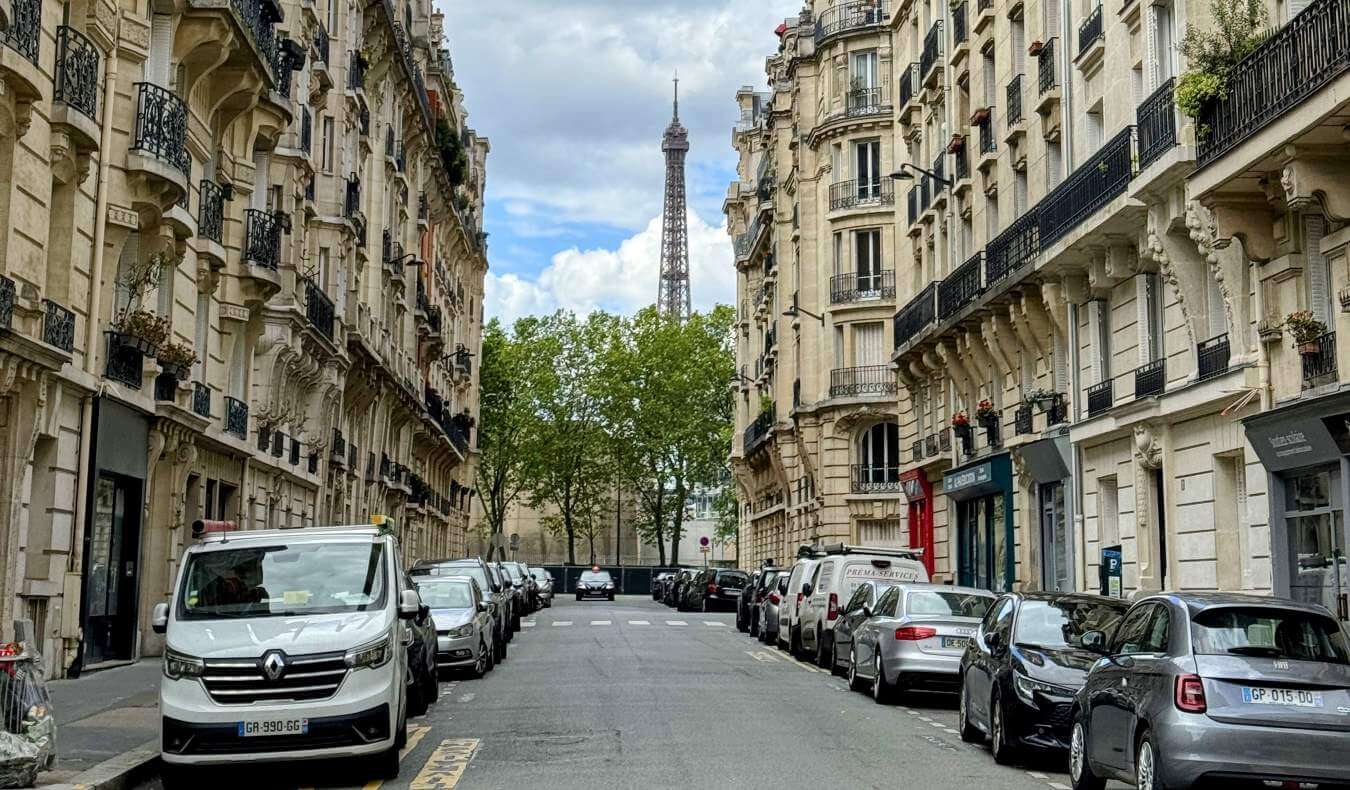 A streetscape in Paris, France, with the Eiffel Tower in the background
