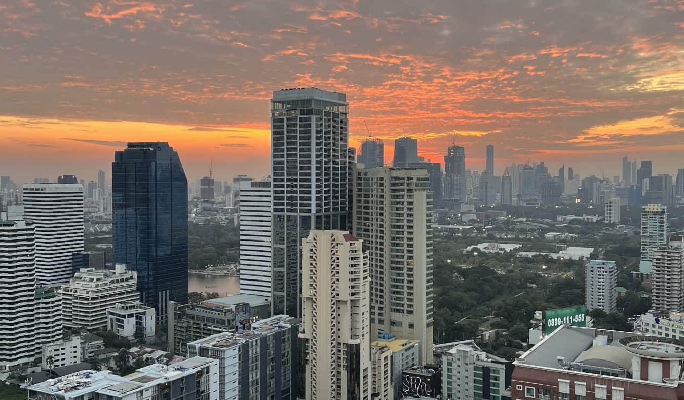 The skyline of Bangkok at sunset with towering skyscrapers all around