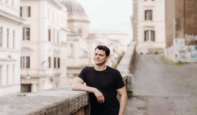 Nomadic Matt posing for a photo in beautiful, historic Rome, Italy