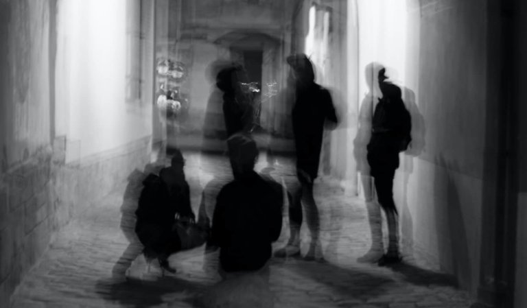 A blurry photo of men hanging out at night