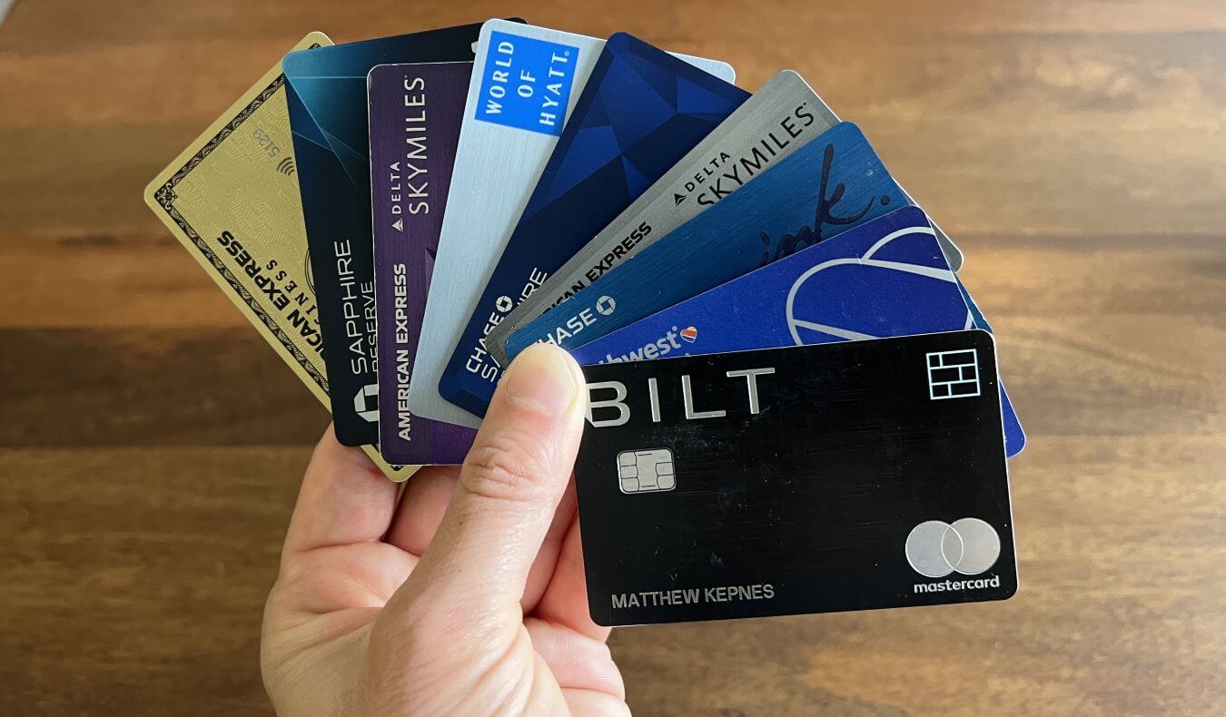 Nomadic Matt holding a fan of his credit cards