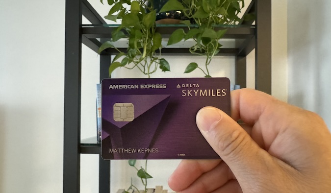 Picture of Nomadic Matt holding his Delta Reserve Credit Card