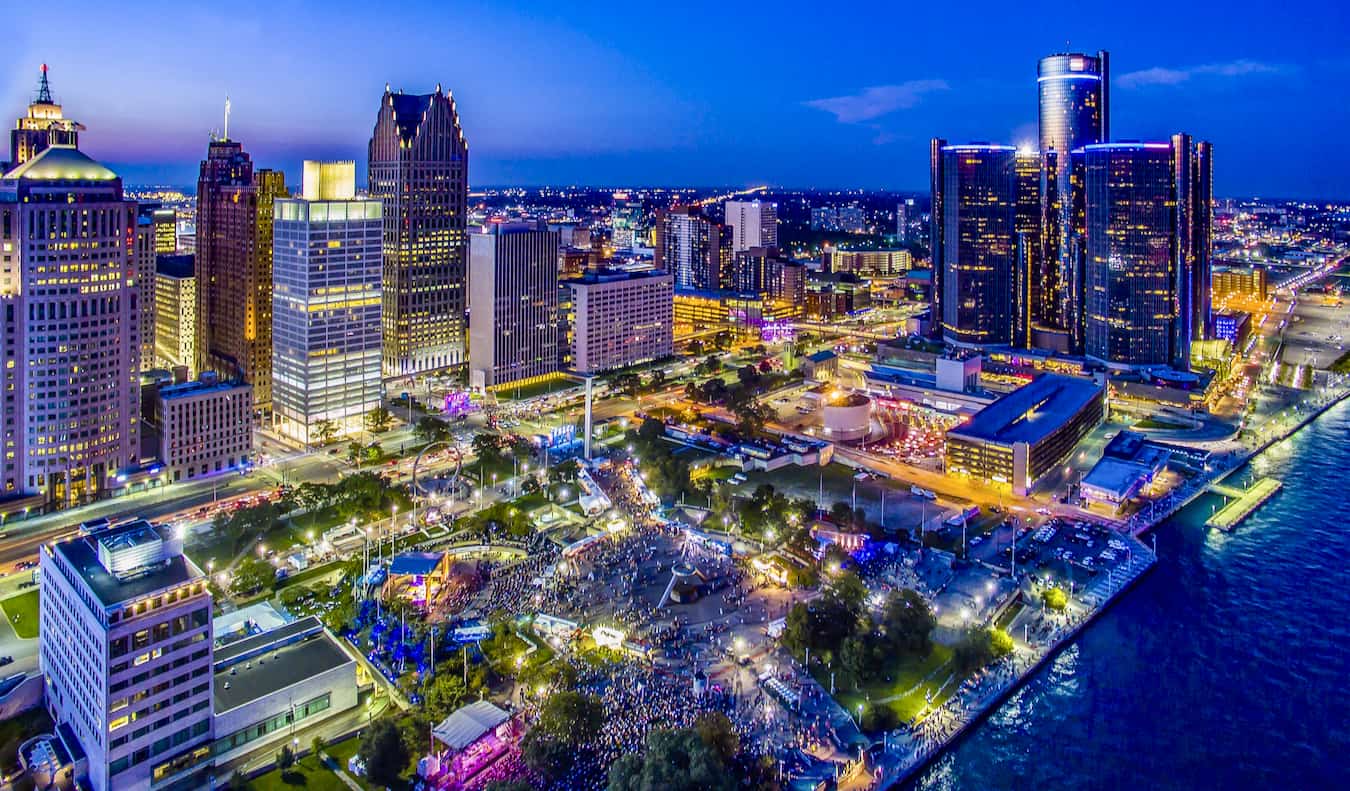 The towering downtown skyline of Detroit, Michigan lit up during the evening