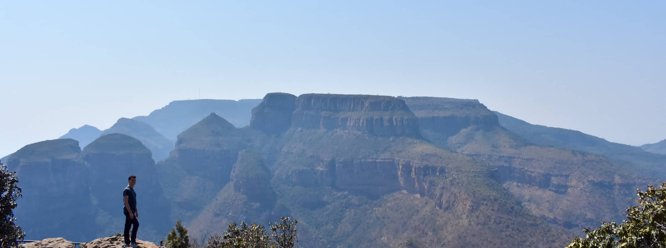 Nomadic Matt posing for a photo on a huge cliff in South Africa
