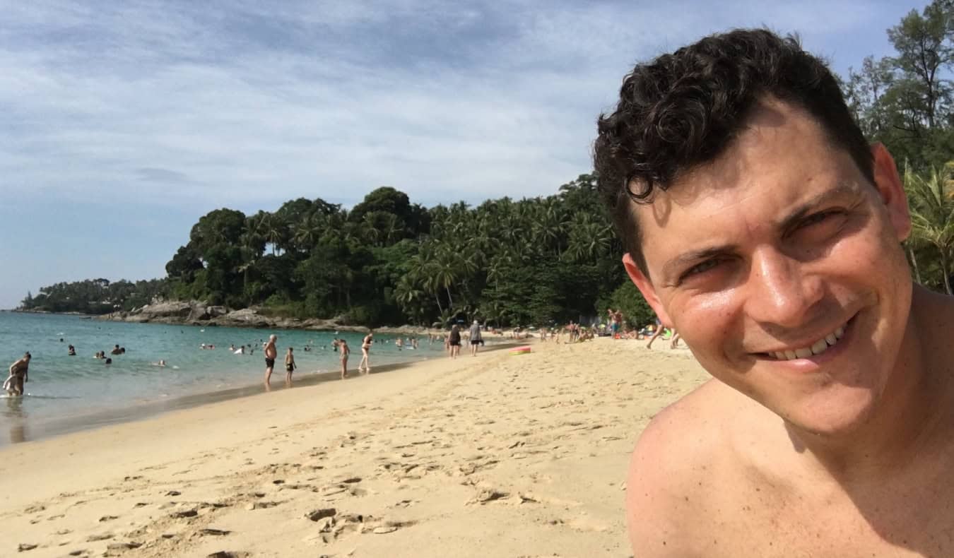Nomadic Matt on a beach in Thailand