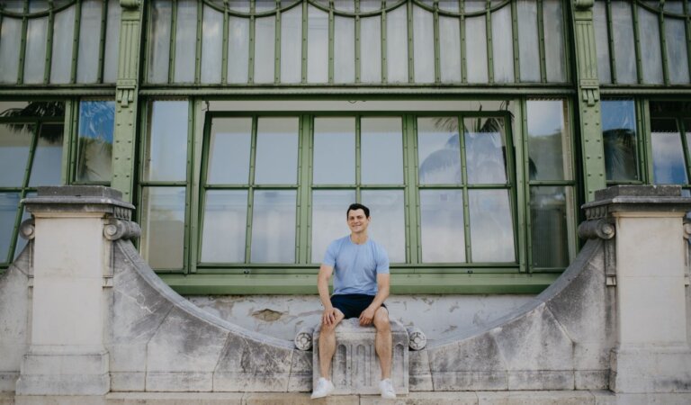 Nomadic Matt sitting on a bridge in Vienna, Austria