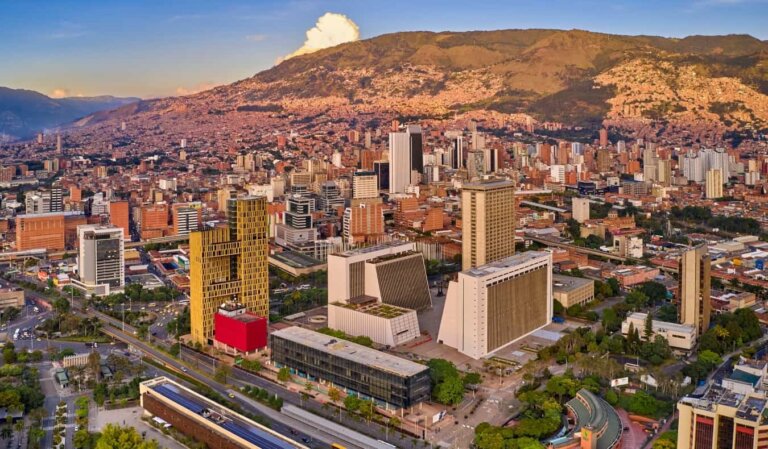 Overlooking the buildings and surrounding mountains of Medellin, Colombia at sunset