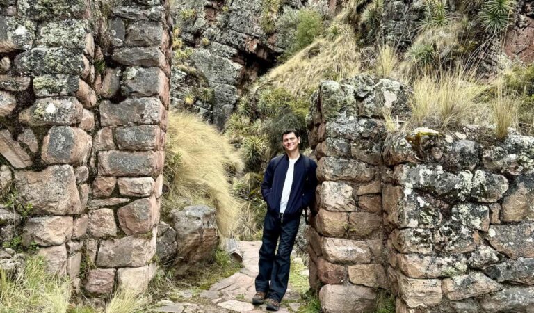 Nomadic Matt posing in the ruins of the famous Sacred Valley in Peru