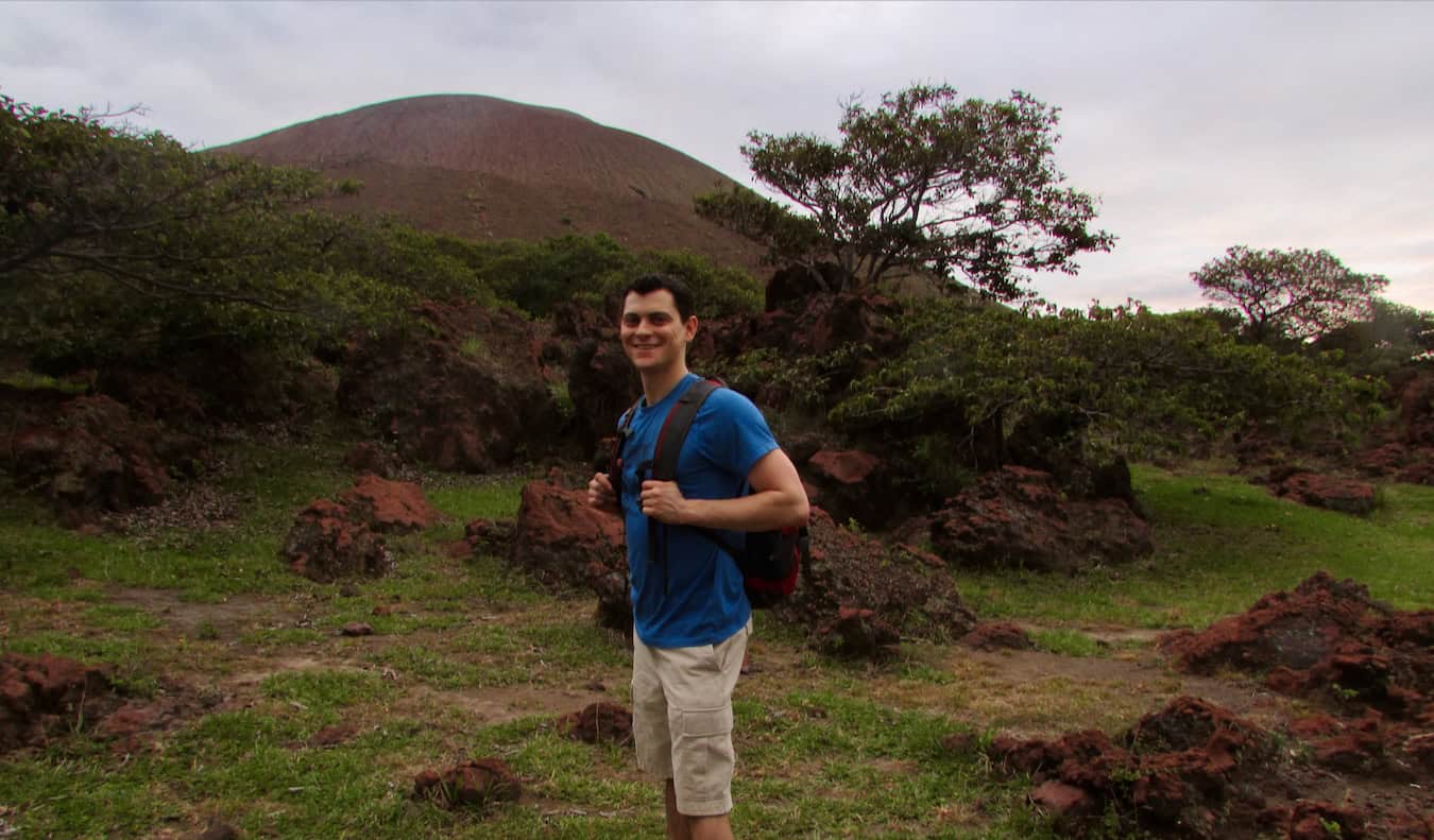 Nomadic Matt posing for a photo during an epic hike on a volcano in beautiful Nicaragua