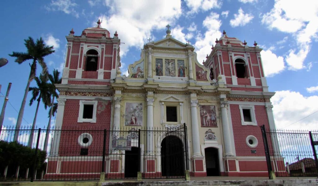A tall and historic building on a sunny day in Leon, Nicaragua
