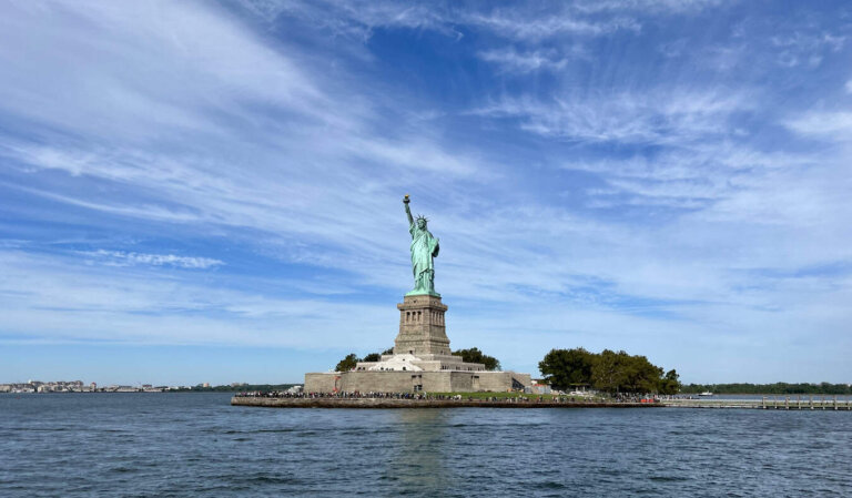 The towering and iconic Statue of Liberty in NYC on a sunny summer day