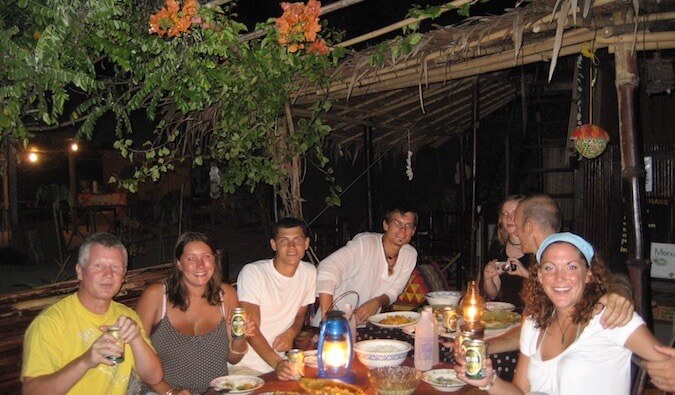 Nomadic Matt hanging out with other travelers at night