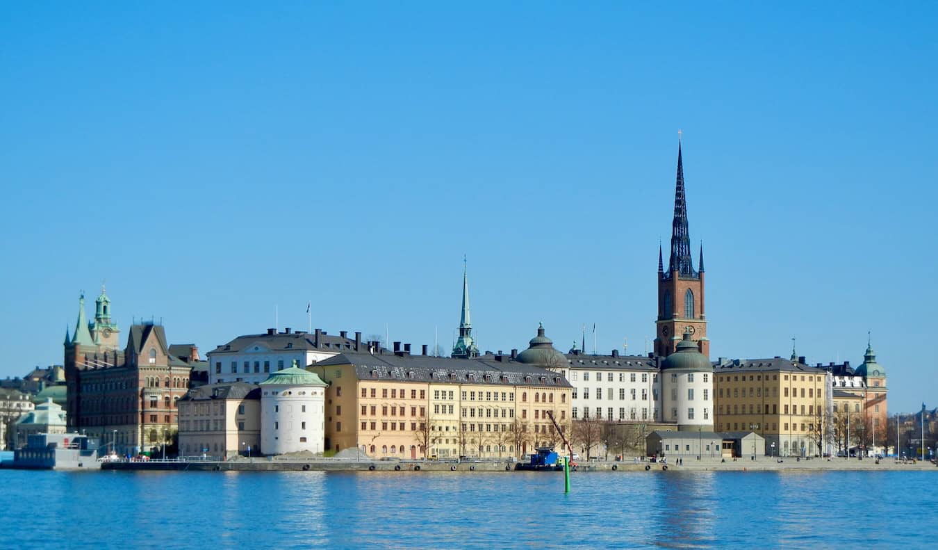 Old, historic buildings along the water of Gamla Stan in sunny Stockholm on a bright summer day