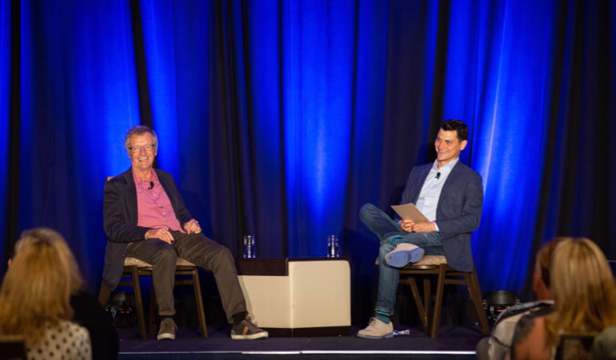 Nomadic Matt interviewing Tony Wheeler at TravelCon 2019 in Boston