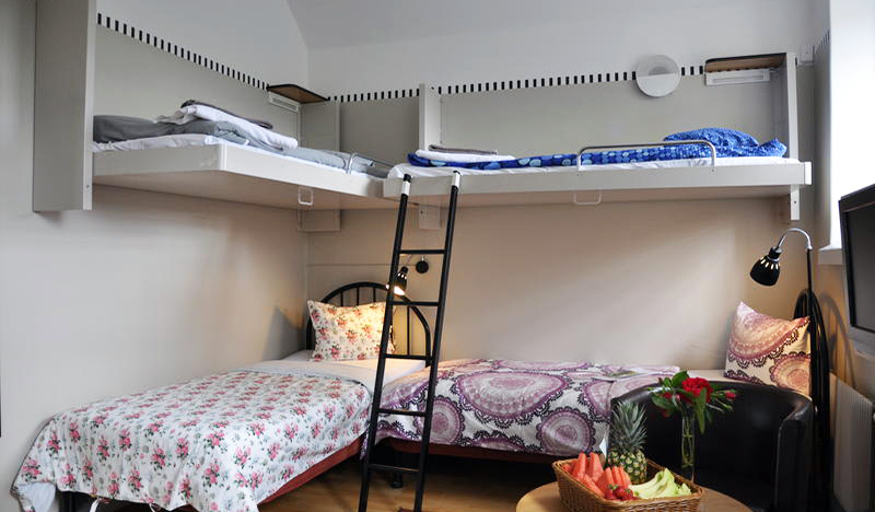 Bunk beds attached to the wall in L-shape at Långholmens Vandrarhem, Stockholm